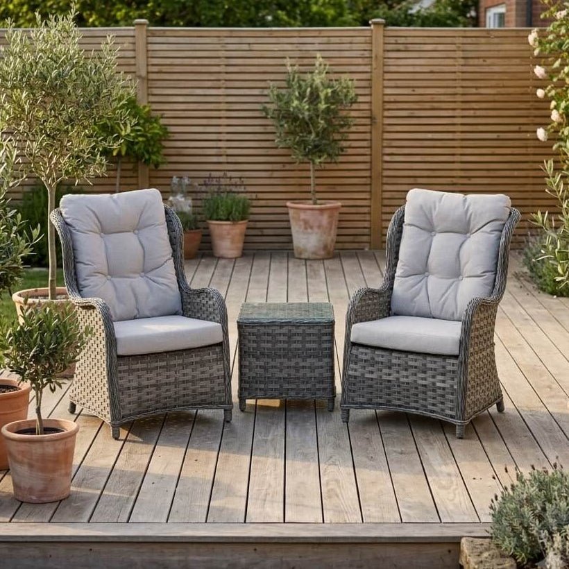 Bermuda 2 seater grey rattan garden chair set with high-back chairs and glass top side table on a decked patio