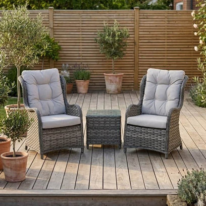 Bermuda 2 seater grey rattan garden chair set with high-back chairs and glass top side table on a decked patio